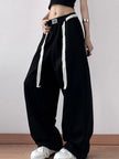 Close-up of drawstring adjustment on relaxed trousers