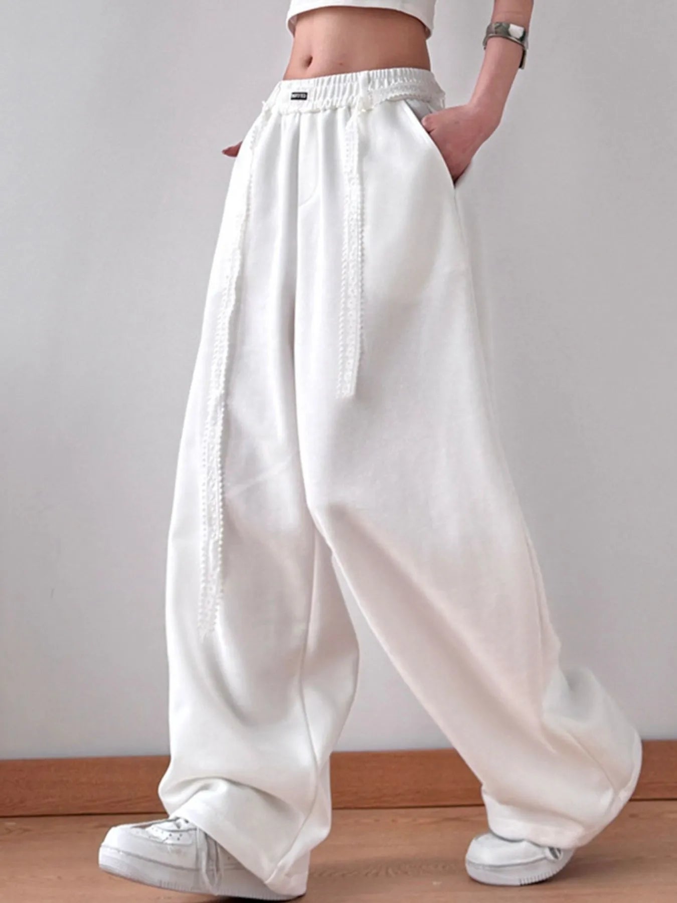 Front view of relaxed wide-leg trousers with functional pockets