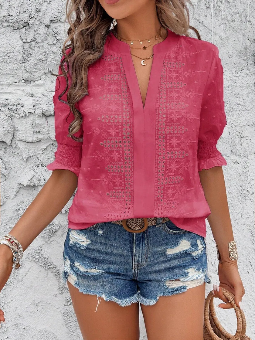 back view of light white blouse showing eyelet pattern and flowy sleeves