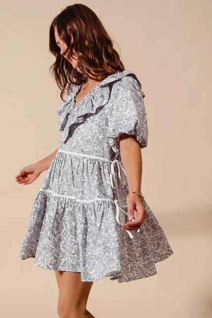 Blue and white floral cotton dress with ruffled V-neck and side tie waist