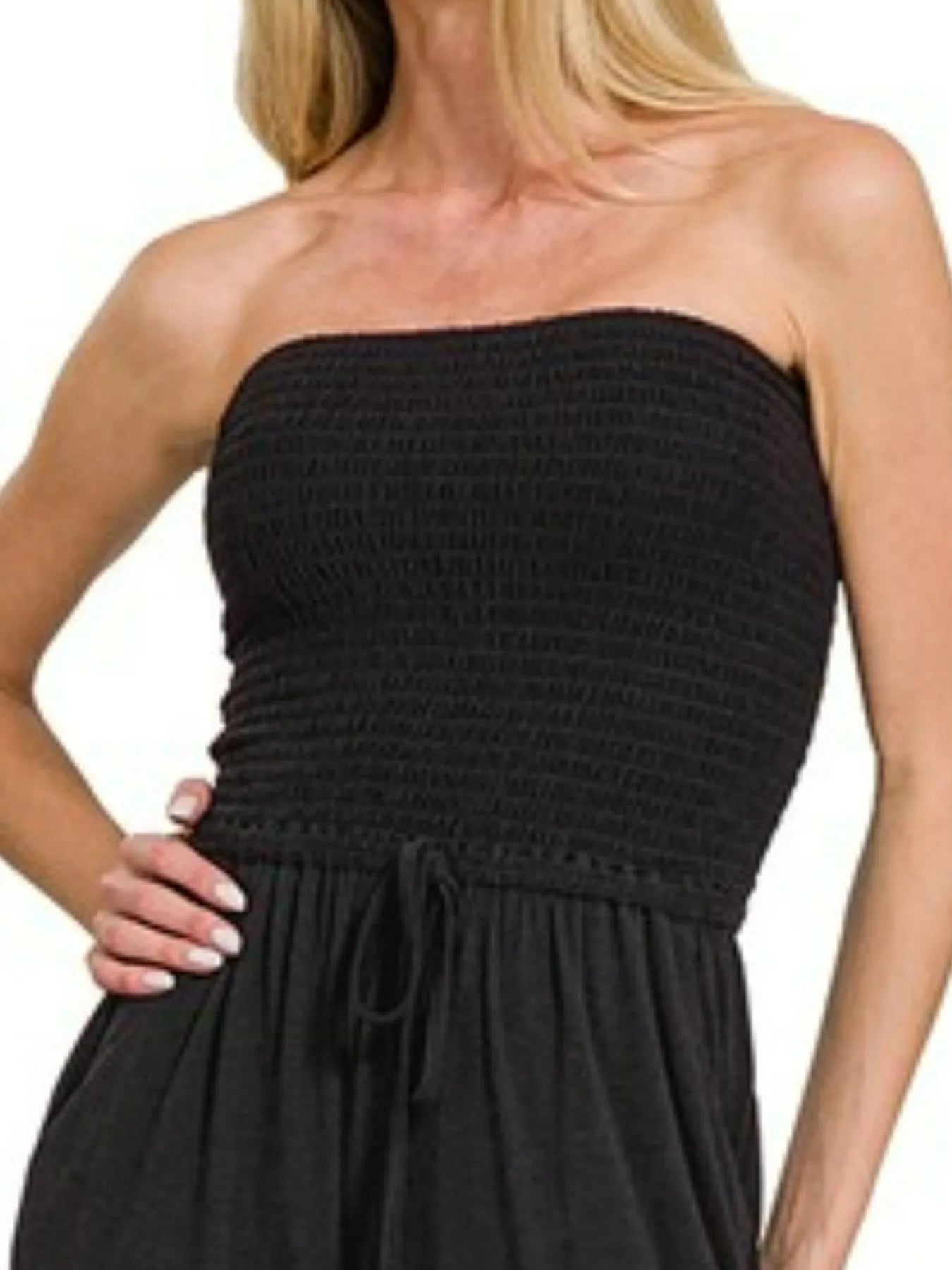 Flowing wide-leg palazzo pants on charcoal black strapless jumpsuit