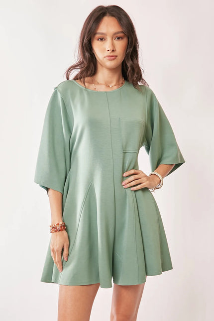 Close-up of relaxed fit romper featuring front pockets and soft fabric texture