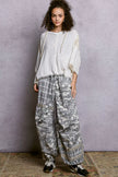 Airy hoodie top with exposed seams and relaxed fit