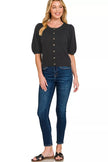 Close-up of ribbed button details on black wool cardigan