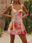 Pink coral floral print lace-up mini dress with corset-style bodice and ruffled hem.