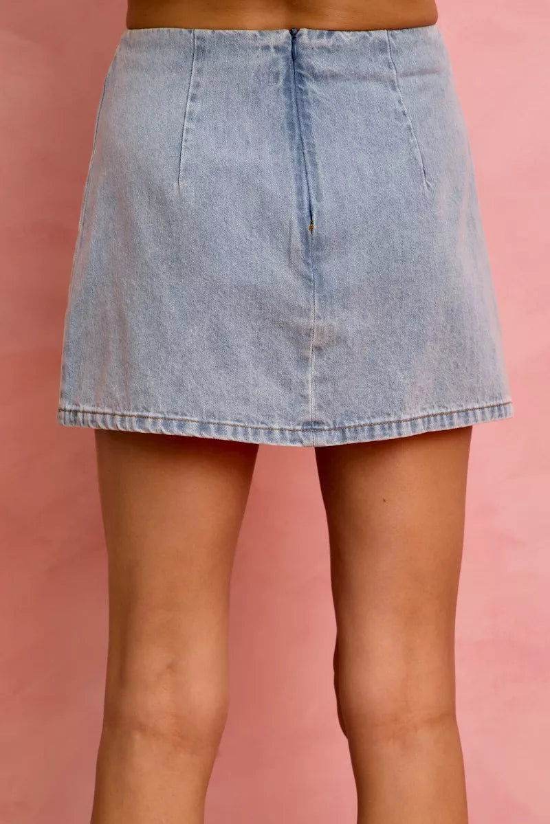Light wash blue denim mini skirt with a structured fit and rear seam
