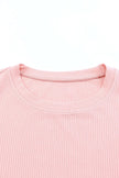 Soft pink ribbed knit round neck cap sleeve blouse close-up