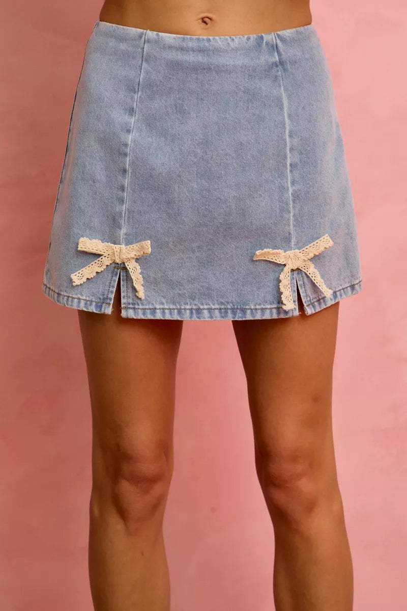 Light blue denim mini skirt with cream lace ribbon bows and slit hem
