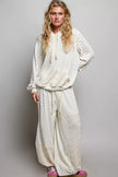 Cream mixed knit wide leg balloon pants featuring patchwork floral prints and lace detail