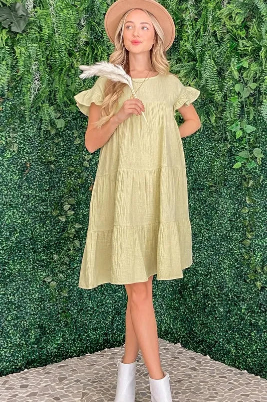 Lime green cotton gauze babydoll dress with ruffled tiered sleeves and loose fit
