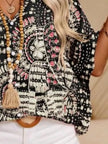 Black and white patterned V-neck top with pink accents, opaque polyester blend, loose fit
