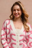 Pink and cream textured heart patterned v-neck cardigan with pearl buttons