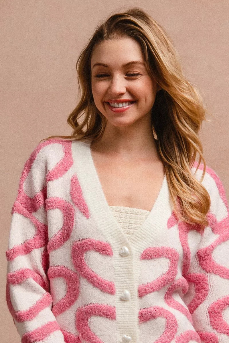 Pink and cream textured heart patterned v-neck cardigan with pearl buttons