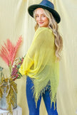 Vibrant lime green mesh sweater cover-up with frayed hem and relaxed fit over blue jeans