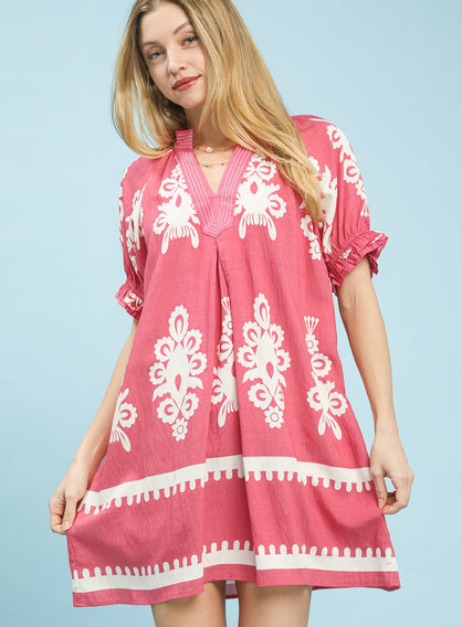 Pink mini dress with white border and floral print, ruffled sleeves, and loose linen fit.