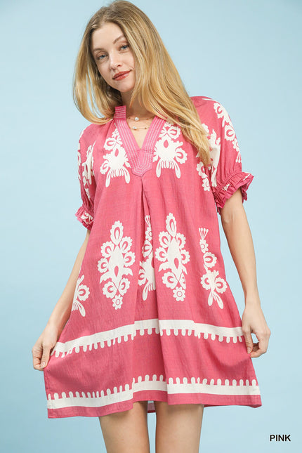 Pink mini dress with white border and floral print, ruffled sleeves, and loose linen fit.