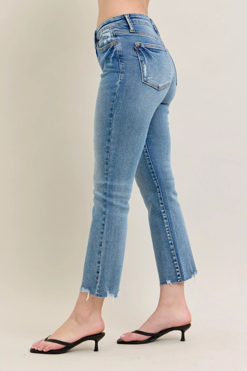 Light blue vintage wash denim jeans with distressed details and frayed kick flare hem in a slim fit