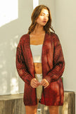 Shimmering red metallic knit V-neck open cardigan with loose fit and textured fabric.