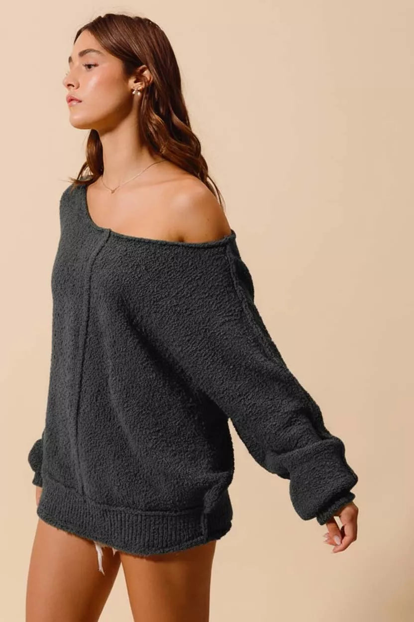 Close-up of boucle sweater showing ribbed texture and exposed seams