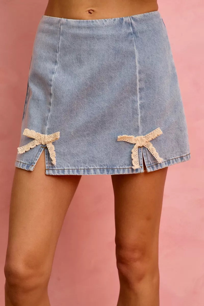 Light blue denim mini skirt with cream lace ribbon bows and side slits