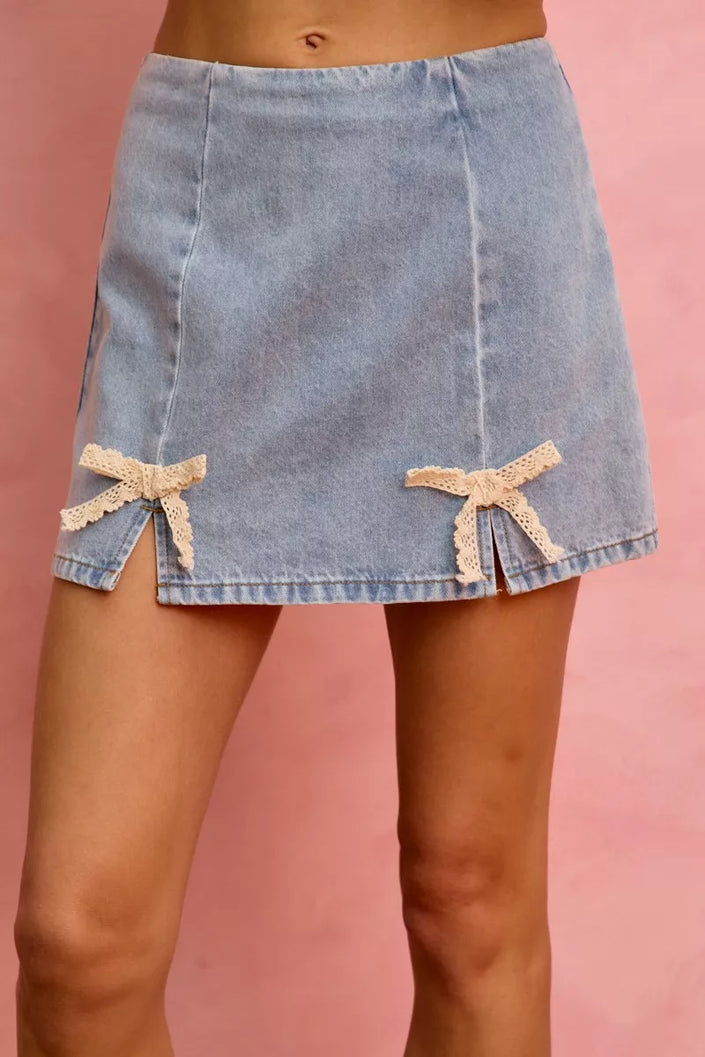 Light blue denim mini skirt with cream lace ribbon bows and side slits
