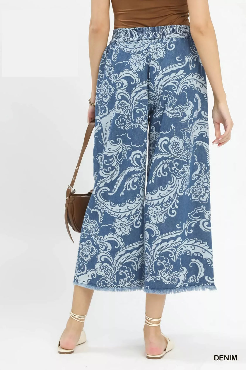 Blue stone wash denim wide leg cropped pants with white floral print frayed hems