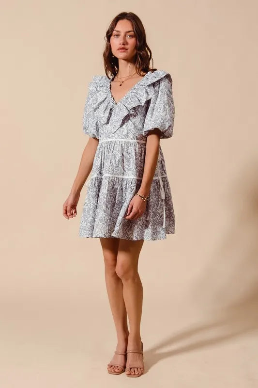 Light blue and white floral cotton dress with ruffled V-neckline and side tie waist