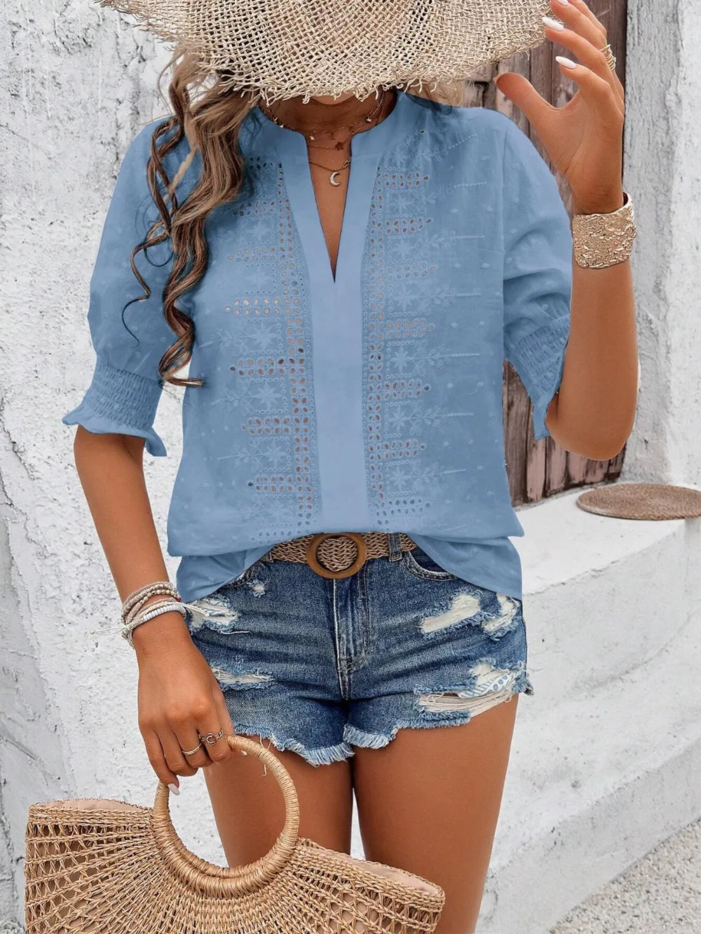 white eyelet blouse with feminine flounce sleeve movement on a model