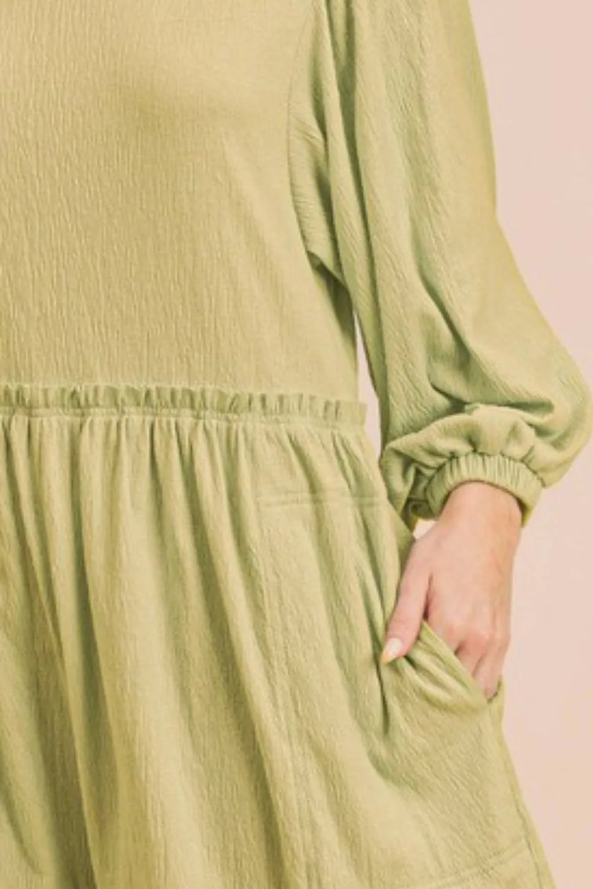 Chartreuse romper showcasing pocketed design and lightweight fabric