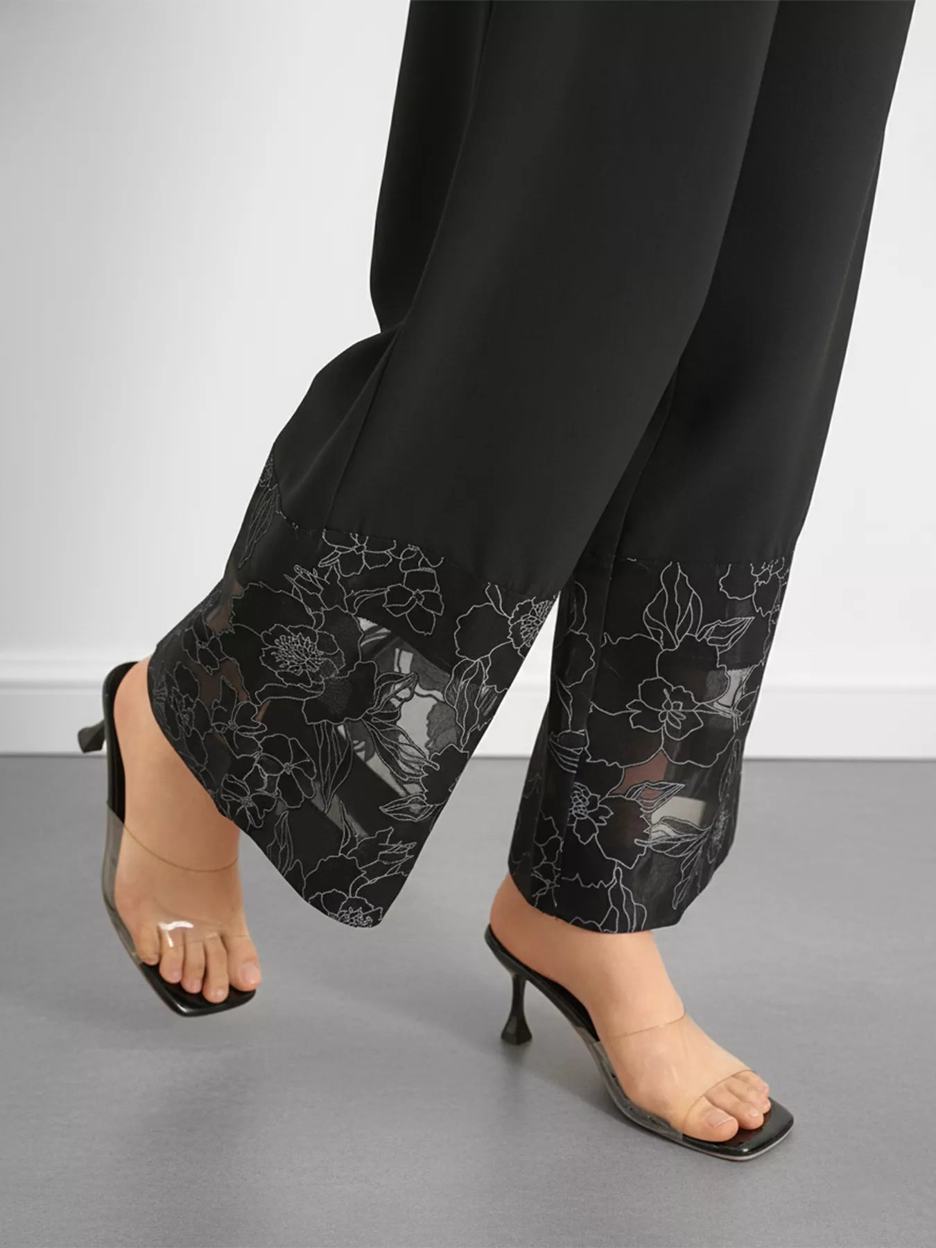 High-rise lace hem wide leg pants displayed on mannequin